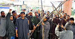 Villagers protest against the Power Development Department over erratic electricity supply in Anantnag on Thursday