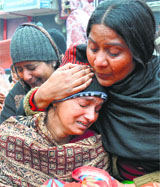 Kirandeep Kaur, with her daughters body in Bathinda on Thursday.