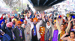 BSP leaders and workers raise slogans against the state government in Amritsar on Friday