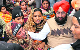 PPCC president Partap Singh Bajwa consoles the wailing mother of the infant who died yesterday amid the teachers protest in Bathinda on Friday.