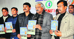 Cabinet minister Dinesh Aggarwal and members of the Young Star Cricket Club release a book in Dehradun on Friday. A Tribune photograph