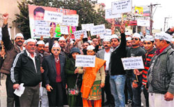Members of the district unit of the Aam Aadmi Party hold a protest in Haridwar on Friday. A Tribune photograph