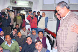 Chief Minister Harish Rawat tries to pacify the protesting BJP legislators who staged a dharna in the Assembly in Dehradun on Friday. A Tribune photograph