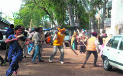 Villagers and lawyers throw stones at each other during a violent clash at the court complex at Roshanabad in Haridwar on Friday.
