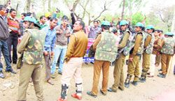 Police personnel try to stop protesters from approcahing MP Ashok Tanwars yatra in Sirsa on Friday. A Tribune photograph