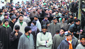 Residents of Ratnipora village in south Kashmir's Pulwama district stage a protest against the government for not granting block status to their village on Friday.