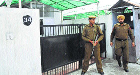 A security personnel outside the residence of Health Minister Shabbir Khan in Jammu on Friday.