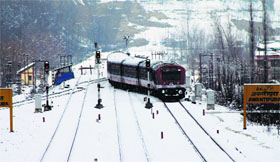 A train runs in snow-bound Awantipora in Pulwama district