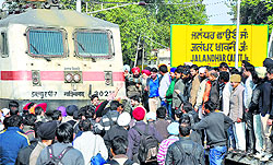 Harassed commuters protest in front of the Paschim Express at the Jalandhar Cantonment Railway Station