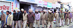 Several police personnel marching through Malout town on Friday
