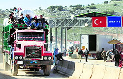 Refugees cross the Syrian border with Turkey at Bab al-Hawa as evacuation began on Friday
