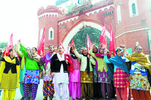 Mid-day meal workers hold a protest in support of their demands in front of the Hall Gate in Amritsar on Sunday.