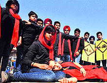 Artistes of the Ludhiana-based Sangharsh group stage a street play against acid attacks in Chandigarh on Sunday