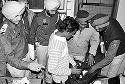 The police check a bag at a PG accommodation in Phase VII, Mohali, on Sunday