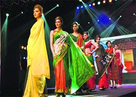 Models walk the ramp during a fashion show at the Surajkund Crafts Mela on Saturday
