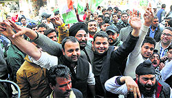 Members of the Pradesh Youth Congress celebrate the inclusion of 73rd Amendment to the Panchayati Raj Act in Jammu on Sunday