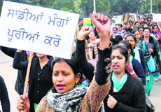 Workers of the National Rural Health Mission stage a protest against the UT Administration in Chandigarh on Monday.