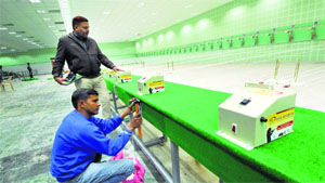 Workers give the final touches to the indoor shooting range at Panjab University on Monday.