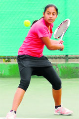 Khushbeen Kaur returns a shot during a match of the Tennis Talent Hunt Tournament at the Tennis Courts, Sunny Enclave, in Kharar on Monday.