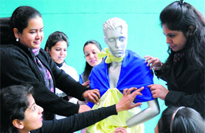Students give the final touches to their project before the presentation at the Northern India Institute of Fashion Technology in Mohali on Monday.