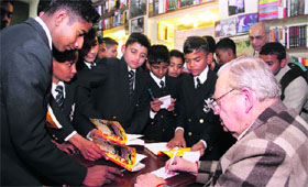 Author Ruskin Bond signs autographs for RIMC cadets in Dehradun on Monday.