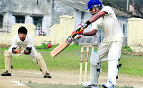 A batsman plays a shot during the Dehradun District Cricket League in Dehradun on Monday.