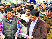 Deputy Commissioner Balraj Singh tries to pacify protesters in Karnal on Monday