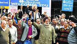 Bank employees stage a protest in Karnal on Monday