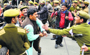 Workers of the BJP scuffle with the police during a protest near the civil secretariat in Jammu on Monday.