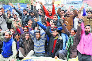 Members of the All J&K Power Development Department Casual Labourers Union protest in Jammu on Monday.