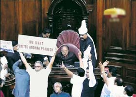 United Andhra Pradesh supporters stage a protest in the well of the Rajya Sabha in New Delhi on Monday