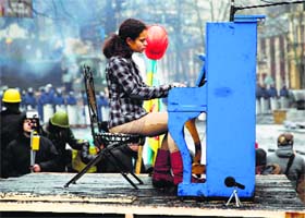 Musical protest: A musician plays a piano near barricades in Kiev on Monday