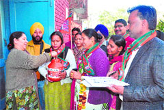 BJP councillor Hira Negi (centre) collects donations in Chandigarh on Tuesday. Tribune photo