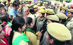 The ETT teachers argue with police personnel when they were stopped from starting their protest march in Jalandhar on Tuesday