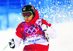Canada's Alex Bilodeau (top) competes during the men's freestyle skiing moguls competition