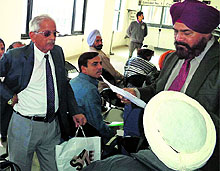Regional Passport Officer JS Sodhi (left) helps people during a lok adalat at the Passport Office in Amritsar on Wednesday