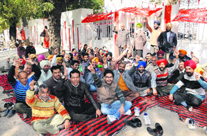 Employees of the Postal Department stage a protest in Bathinda on Wednesday. 