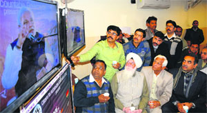 BJPs city unit president Sanjay Tandon (sitting extreme right) along with party supporters during the partys prime ministerial candidate Narendra Modis Chai pe charcha programme at Sector 34 in Chandigarh on Wednesday.
