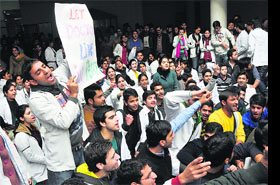 Students of Government Medical College raise slogans against the Medical Council of India in Jammu.