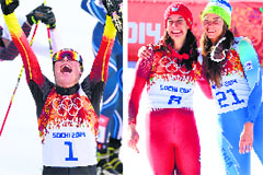 Eric Frenzel celebrates after winning gold in the Nordic combined NH/10 km cross-country; and (right) Dominique Gisin and Tina Maze shared gold in Alpine Skiing Downhill on Wednesday. AFP