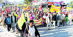 Members of the Kisan Khet Mazdoor Union hold a protest march in Bathinda on Thursday