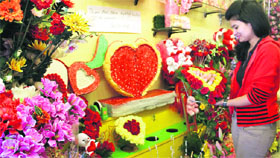 A girl selects a bouquet on the eve of Valentines Day at a gift shop in Dehradun on Thursday.