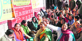 Postal employees stage a dharna in support of their demands in Dehradun on Thursday.