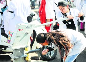 Students of Government Medical College quench thirst at a hand pump during the protest in Jammu on Thursday