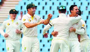 Mitchell Johnson (right) celebrates with teammates after taking the wicket of Faf du Plessis during the second day of the first Test in Centurion on Thursday. 