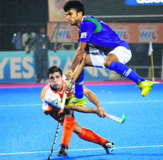 Nikkin Thimmaiah of Uttar Pradesh Wizards jumps to get out of harms way during the HIL match on Thursday.