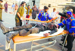An injured cop being taken to a hospital after a bomb attack on a police bus in Karachi on Thursday. AFP 