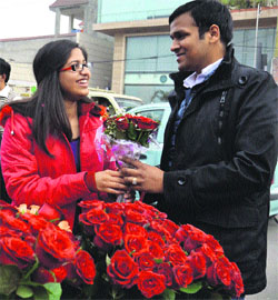 A young couple celebrates Valentines Day by sharing gifts with each other in Amritsar on Friday.