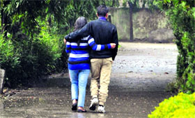 A couple enjoys a walk in incessant rain at Gandhi Park in Dehradun on Friday.