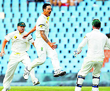 Mitchell Johnson leaps in the air as he dismisses one of his seven victims on Friday